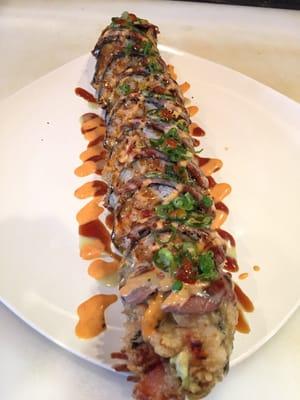 angry sumo ! scallops crabmeat and veggies all rolled up , tempura , then topped with seared ribeye with all 4 house sauce