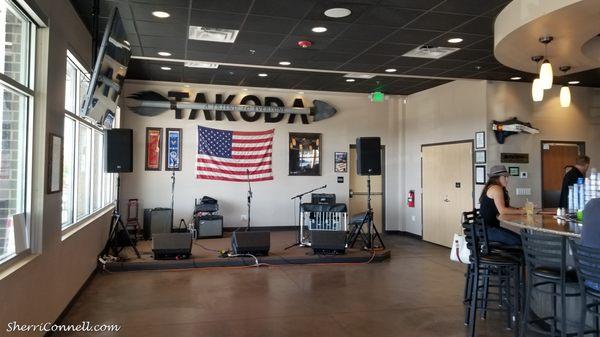 Takoda Tavern. Inside view of stage, next to the bar and open dining area.