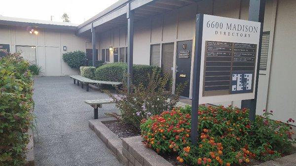 Enjoy the beautiful plants surrounding the office building.