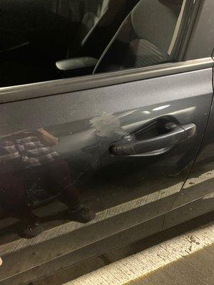 Large scratch and weird smudge by drivers door handle.  This is "clean" to Budget.