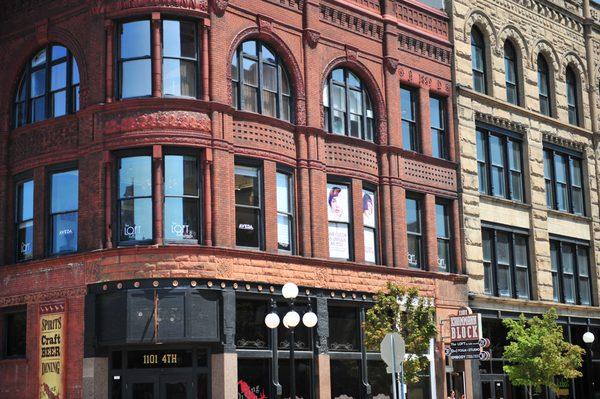 Historic façade of the building in downtown Sioux City, showing Belle  Salon & Spa on the second floor.