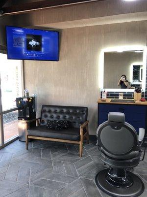 Waiting area bench (there are two, one on each side of entrance) & Tv's playing music in background or movies.