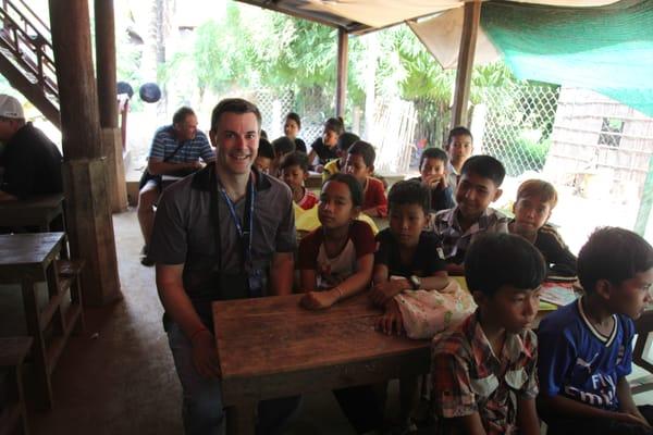 Michael learning to speak English with the school kids in Cambodia