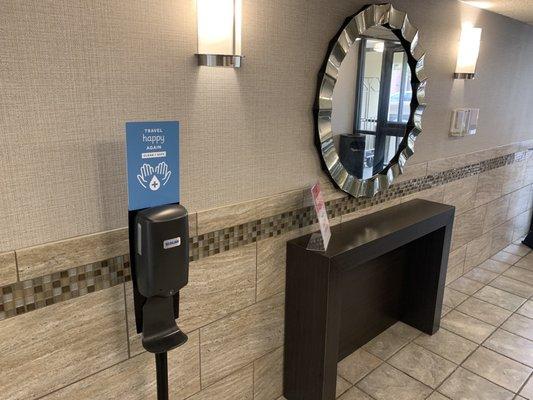 Sanitizer station at elevators.