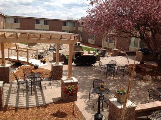 courtyard with grill, fireplace, stream and comfortable seating