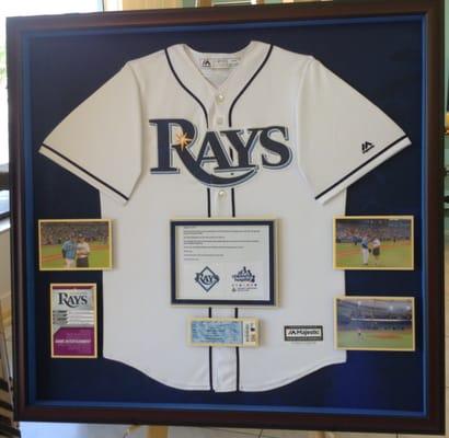 A customer brought this jersey in with photos of himself throwing the first pitch at a Rays game.