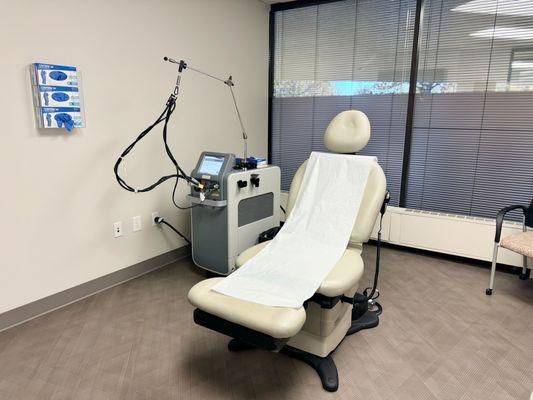 Clean and modern exam room equipped with a state-of-the-art laser hair removal machine - a comfortable and lasting option for unwanted hair.