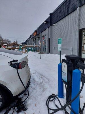 Free electric car charging next to the patio