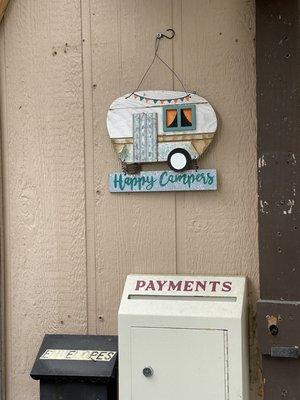 Happy Camper sign above payment drop box