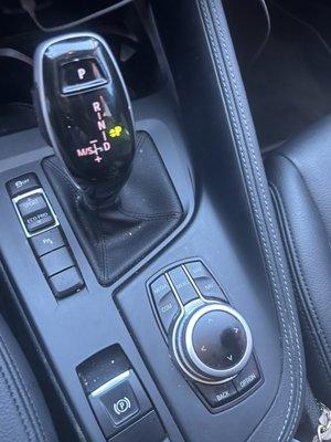 Center console with crumbs and cup holder that was dirty.