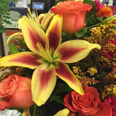 Beautiful fall lily with orange roses and solidago