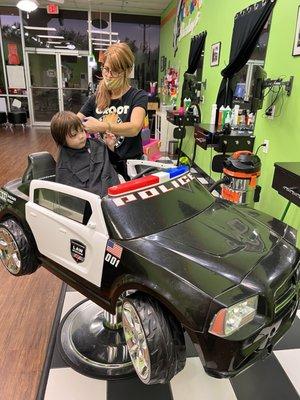 Very impressed with DJ's talented skills to get our squirmy toddler to sit for his haircut! Cars movie, candy and toys!