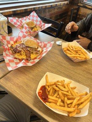 Cheese burger with mini skirt, grilled onions and bacon with a large fry.