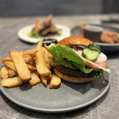 Wagyu Burger w/ tomarashi cheese, lettuce, tomato, onion, pickle, miso aioli, toasted brioche bun, fries ($25)