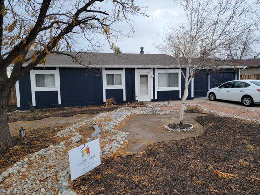 Colorado Springs painters turning this white house into a blue house with Sherwin-Williams paint.