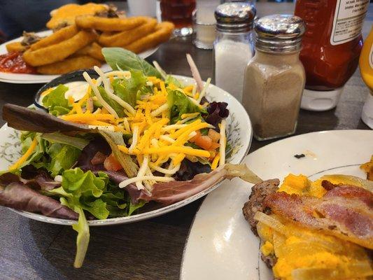 The Bob Burger (bun set aside), side salad, and husband's onion rings in the background.