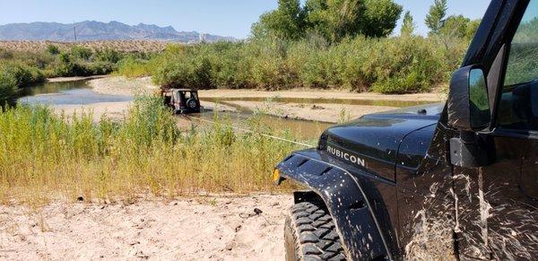 Getting a stuck jeep out of the river.