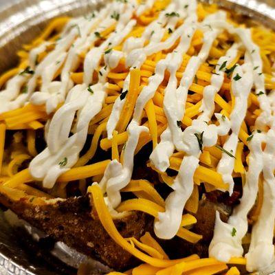 Plain jane is sautéed bacon topped with cheddar cheese and sour cream all laid inside of a baked potato $14 856.765.5940 or fullpotatoes.com