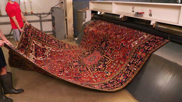 Expert Rug Cleaning - a rug going through our state of the art wringer to dry them quickly and efficiently.