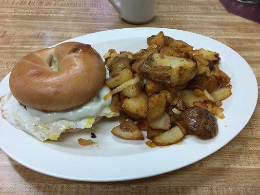 Sausage, Egg, and Cheese on a Griddled Bagel, with a side of Griddled Home Fries with Onions. Delicious!