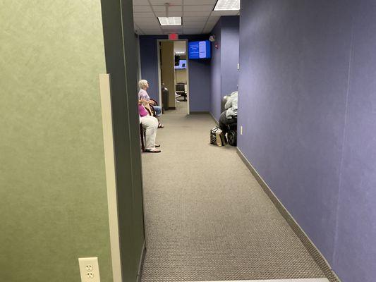 This is the hallway/waiting area. It is typically full with no seating available.