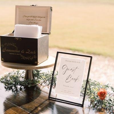 Black floating frame with guest book and flared pedestal stand