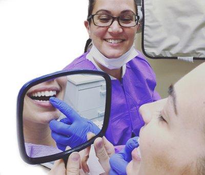 Dr. Kramer showing her beautiful  Veneer to her patient!