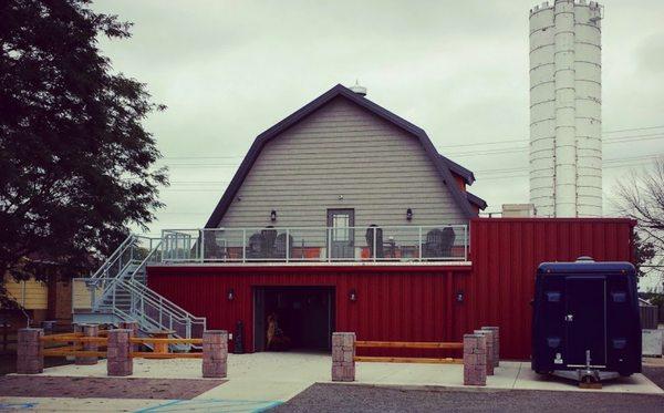 Outside back, showing upstairs and downstairs options. Taken from the gravel parking lot.