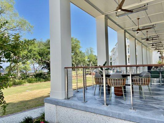 the restaurant has a covered porch with waterfront views