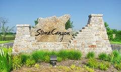 South West Stones, Six shooter building stone entry way with a decorative entry boulder at the Stone Canyon Living Community