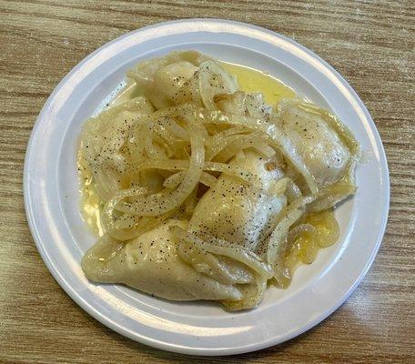 Potato and cheese pierogies with onions and butter.