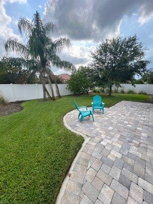 Back yard lawn maintenance with patio edging.