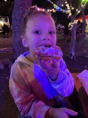 Charlie deconstructing her funnel cake ice cream sandwich  topped with sprinkles