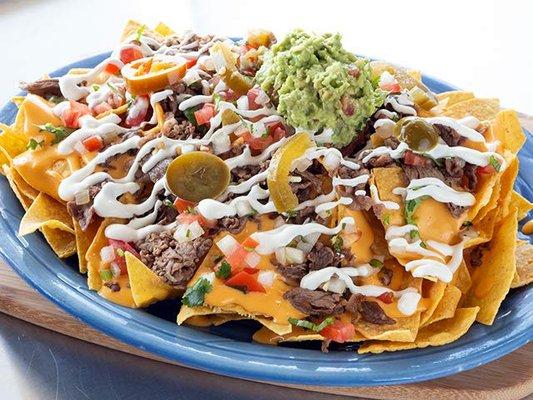 •	SUPER NACHOS      9 loads of chips, meat, cheese, topped w/ guacamole,  sour cream and pico de gallo