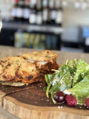 Panuozzo with milanese and eggplant  and spinach salad