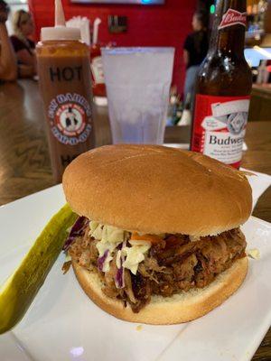 Fat daddy pork sandwich with hot sauce and Budweiser.