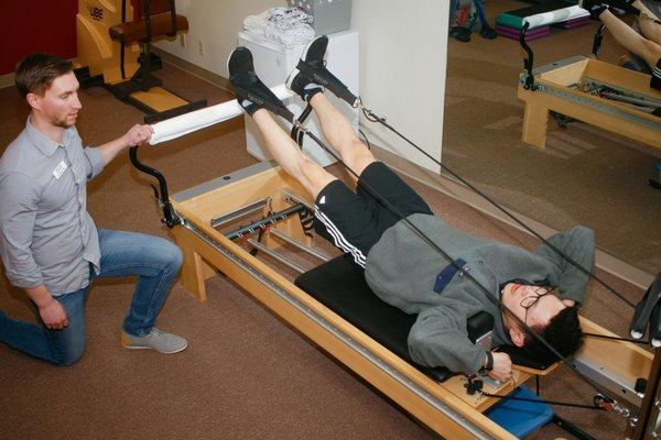 Physical Therapist, Dr. Ian Gilkison overseeing pilates reformer training. Photo by: Jennifer Twist