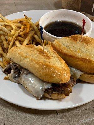 Prime rib French dip sandwich and fries.