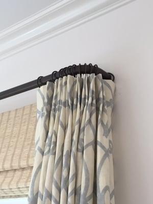 Soft angle return rods use the projection of the bracket to stack the curtain off the window. Very helpful for tight spaces.