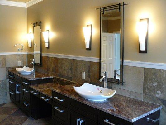 Bathroom with drop down make-up area and vessel sinks