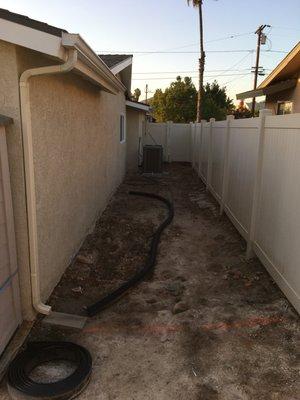 Before concrete.  Where AC unit is placed.