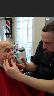 Taking care of the elderly community making sure every strand of hair is groomed and finished off with a hot towel lather shave