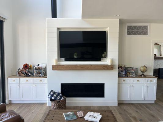 Living room built-ins, including custom framed fireplace, mantle, and TV niche.