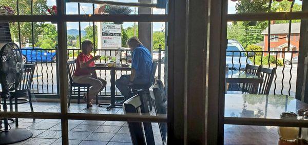 A couple enjoying food on the nice patio