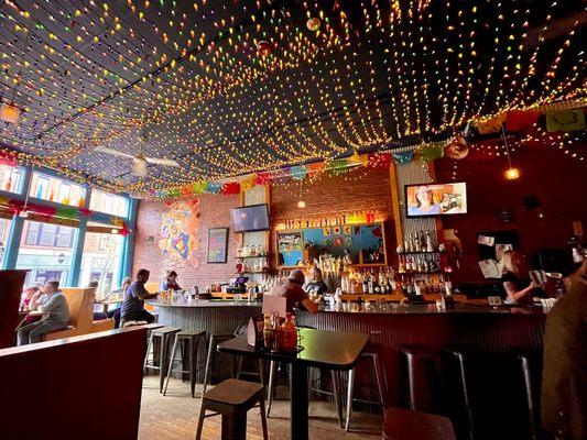 Restaurant interior with a ceiling full of festive chili pepper lights