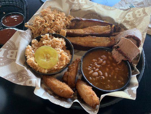 Ribs, pulled chicken, brisket, bbq beans, red slaw, hush puppies.