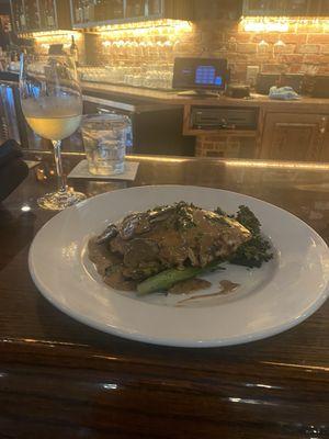 Chicken Marsala with mashed potatoes and broccolini.