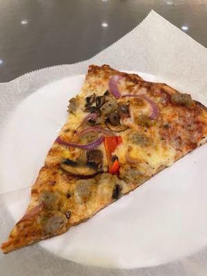 Sausage, onion, mushroom pizza slice.