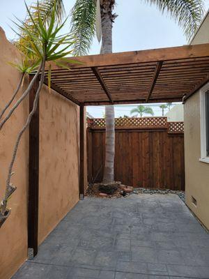 Almost done. New pergola, fence, and stucco wall on left.