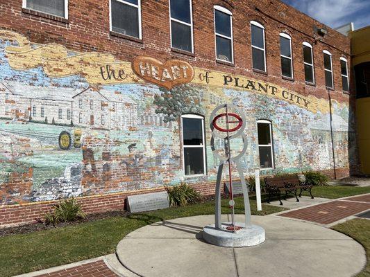 Faded, peeling mural depicting the "Heart of Plant City."